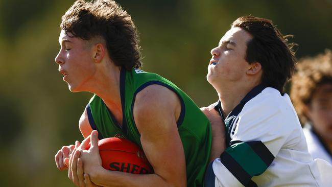 Mitchell Moate of Parade College marks the ball under pressure from Ned Loft of St Patrick's College. Picture: Daniel Pockett/AFL Photos/via Getty Images