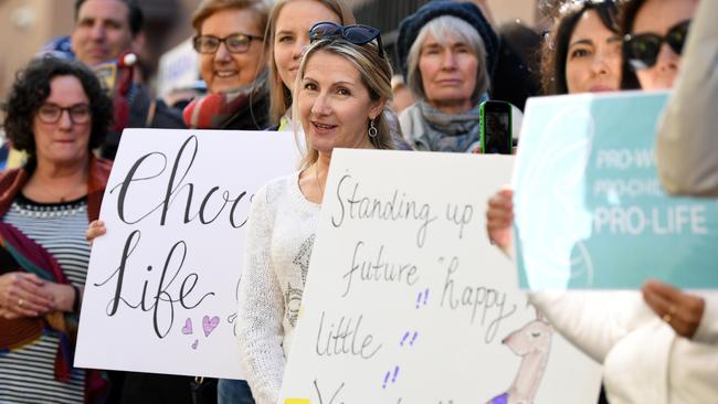 Anti-abortion protesters hold signs during a rally outside the NSW Parliament House. Picture: AAP