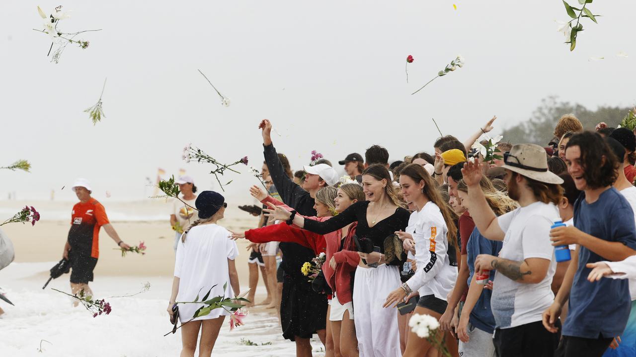 Family and friends of 16-year-old alleged stabbing victim Balin Stewart gather to pay tribute on his home beach at Buddina. Picture: Lachie Millard