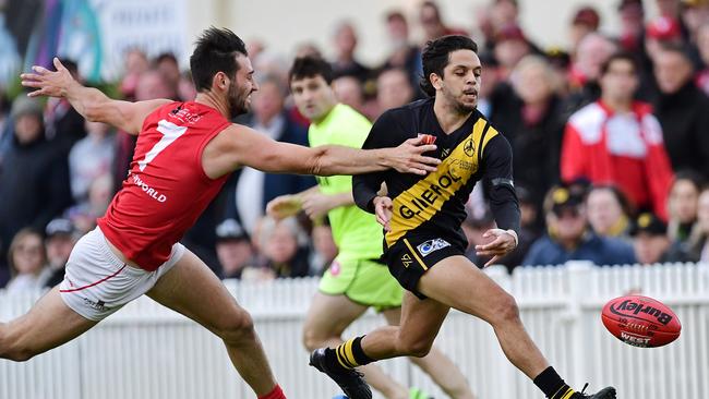 Glenelg's Ian Milera out runs North's Tanner Smith at Glenelg Oval. Picture: Tom Huntley