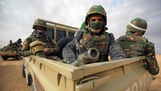 Members of the Iraqi forces and paramilitaries of the Hashed al-Shaabi (Popular Mobilisation units) ride in the back of Toyotas in the western desert bordering Syria in 2017 in a bid to flush out remaining Islamic State fighters.