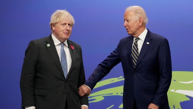 British Prime Minister Boris Johnson (L) greets U.S. President Joe Biden at COP26 in Glasgow, Scotland.