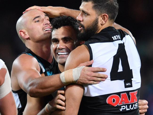 (L-R) Sam Powell-Pepper, Lindsay Thomas and Patrick Ryder of the Power celebrate a goal during the Round 13 AFL match between the Port Adelaide Power and the Western Bulldogs at Adelaide Oval in Adelaide, Thursday, June 14, 2018. (AAP Image/David Mariuz) NO ARCHIVING, EDITORIAL USE ONLY