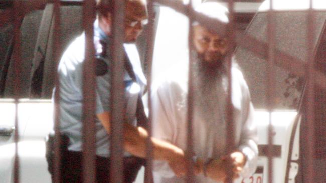 Abdul Naser Benbrika is escorted from the Victorian Supreme Court after his conviction and sentencing on terrorism charges.