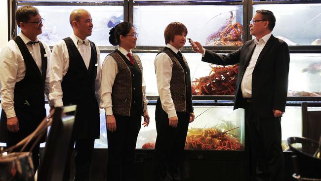 Owner of Sydney restaurant Golden Century Eric Wong checks the temperatures of staff members before lockdown closed the restaurant. Picture: Sam Ruttyn.