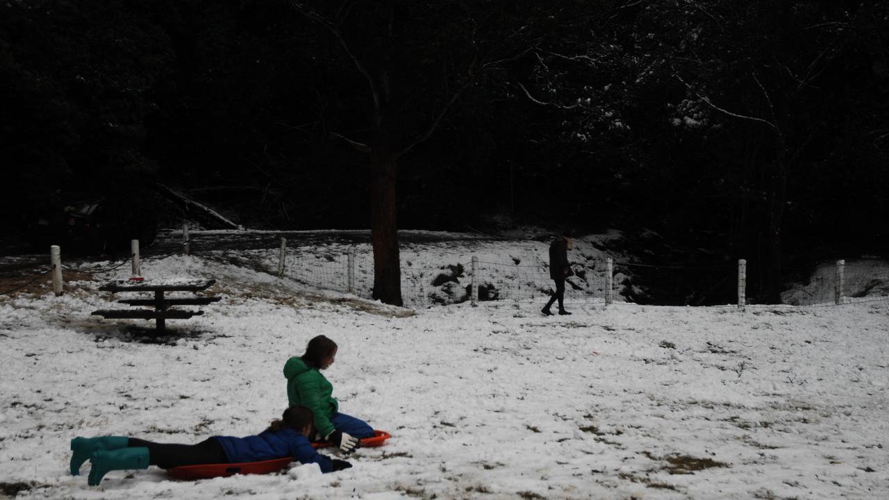 Toboggans were out in force across Tasmania after a rare snowfall which reached sea level and the lowest point in more than a decade. Monday, Aug 3, 2015. (AAP Image/ Andrew Drummond)