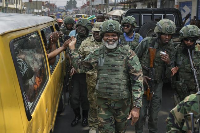 A crumpled Congolese army beret alongside cartridges near an abandoned, bullet-riddled military truck in Goma