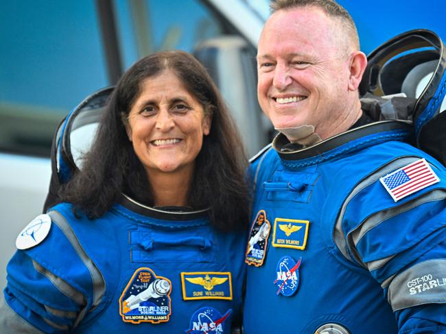 NASA astronauts  Butch Wilmore (R) and Suni Williams, wearing Boeing spacesuits,  depart the Neil A. Armstrong Operations and Checkout Building at Kennedy Space Center for Launch Complex 41 at Cape Canaveral Space Force Station in Florida to board the Boeing CST-100 Starliner spacecraft for the Crew Flight Test launch , on June 5, 2024. Boeing on June 5 will try once more to launch astronauts aboard a Starliner capsule bound for the International Space Station. Liftoff is targeted for 10:52 am (1452 GMT) for a roughly one-week stay at the orbital laboratory. (Photo by Miguel J. Rodriguez Carrillo / AFP)