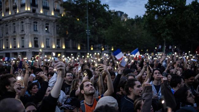 People celebrate during an election night rally following the first results of the second round of France's legislative election. Picture: AFP