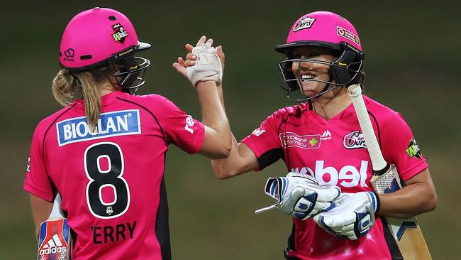 Ellyse Perry and Sara McGlashan celebrate victory for the Sixers during Women's Big Bash League match Sydney Sixers v Brisbane Heat at Drummoyne Oval. Picture. Phil Hillyard