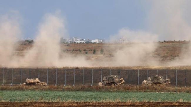 Israeli military vehicles roll near the border with the Gaza Strip on Sunday. Picture: AFP