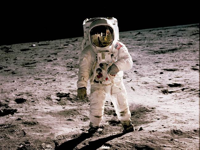 This photo obtained from NASA and taken by Neil Armstrong (reflected on helmet) shows Edwin "Buzz" Aldrin walking on the Moon on July 20, 1969. - When the Saturn V rocket built by Wernher von Braun launched with the Apollo 11 capsule at its summit on July 16 1969, one million people flocked to watch the spectacle on the beaches of Florida near Cape Canaveral. But many had doubts that they'd succeed in landing this time. (Photo by Neil ARMSTRONG / NASA / AFP) / **RESTRICTED TO EDITORIAL USE - MANDATORY CREDIT "AFP PHOTO / NASA" - NO MARKETING - NO ADVERTISING CAMPAIGNS - DISTRIBUTED AS A SERVICE TO CLIENTS **TO GO WITH AFP STORY by Ivan Couronne, "To the Moon and back: mankind's giant leap 50 years on"