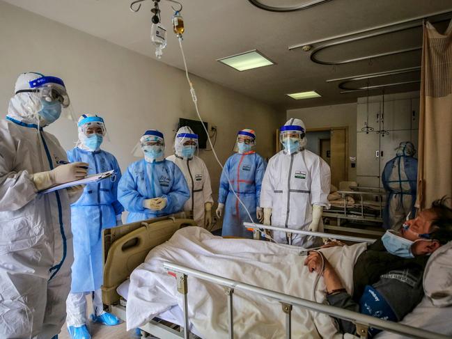 Medical staff speak with a patient infected by the COVID-19 coronavirus at Red Cross Hospital in Wuhan in China's central Hubei province. Picture: AFP