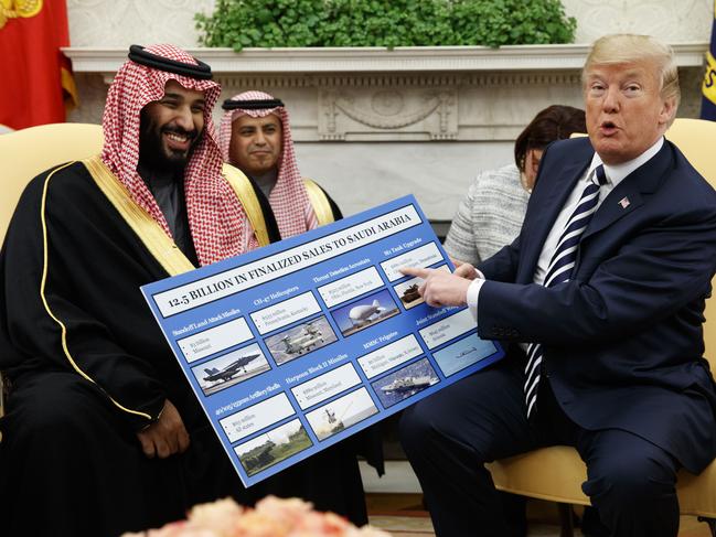 FILE - In this Tuesday, March 20, 2018 file photo, President Donald Trump holds a chart highlighting arms sales to Saudi Arabia during a meeting with Saudi Crown Prince Mohammed bin Salman in the Oval Office of the White House in Washington. (AP Photo/Evan Vucci)