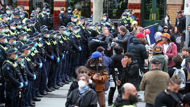 Protesters face off against police on Flinders St. Picture: Rebecca Michael