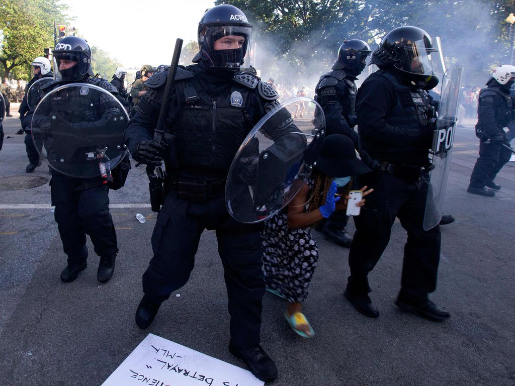 A demonstrator tries to pass between a police line wearing riot gear as they push back demonstrators outside of the White House. Picture: AFP