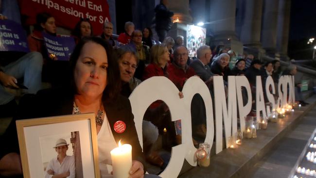 Liz Habermann holds a photo of her son Rhys, who took his own life when he suffered from cancer, at a euthanasia vote vigil on the steps of Parliament House on June 9, 2021. Picture: Kelly Barnes