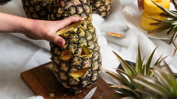 There’s no waste after the pineapple is carved into a spooky lantern. Picture: Supplied