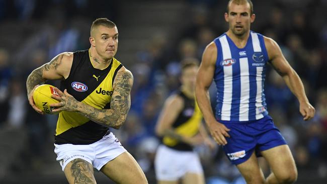 Dustin Martin races away from Ben Cunnington. Picture: AAP