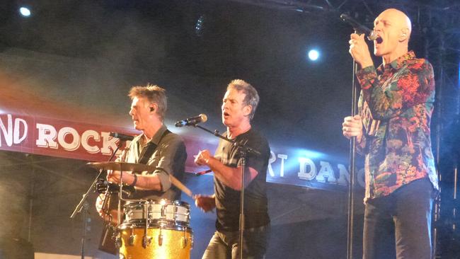 Midnight Oil's Bones Hillman (left), Rob Hirst and Peter Garrett on stage at the Big Red Bash. Picture: News Regional Media