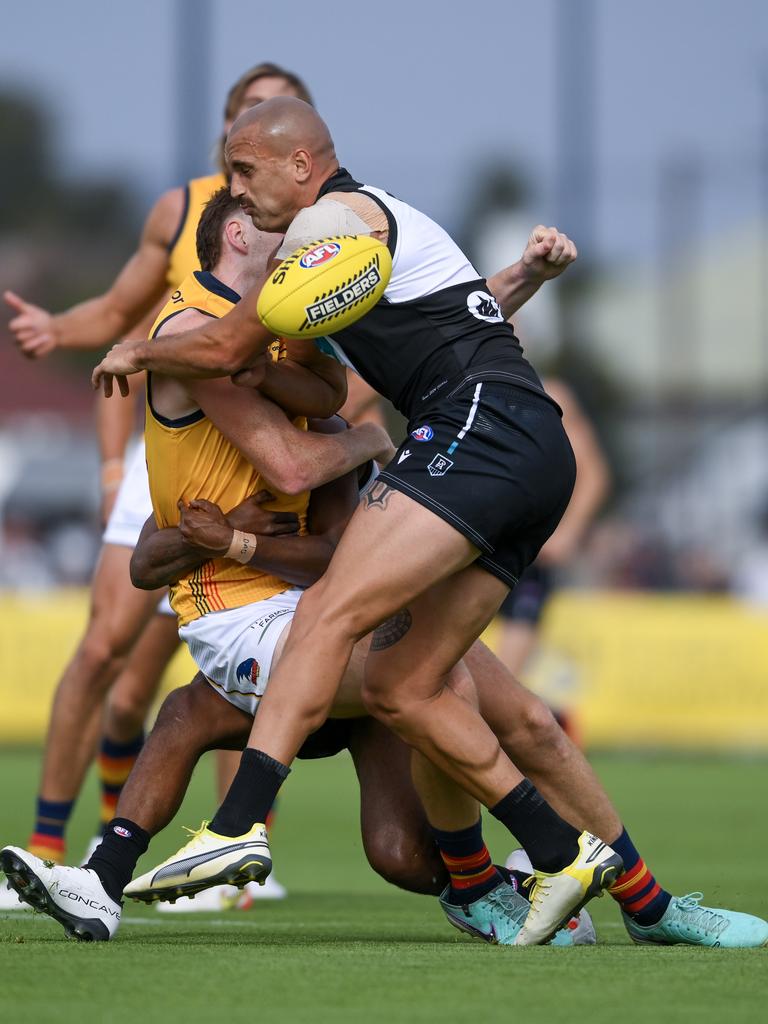 Fellow ALF player Mark Keane of the Adelaide Crows sustained a concussion in Adelaide after this tackle by Willie Rioli and Sam Powell-Pepper of the Port Adelaide Power during a practice match on February 23. Picture: Mark Brake/Getty Images