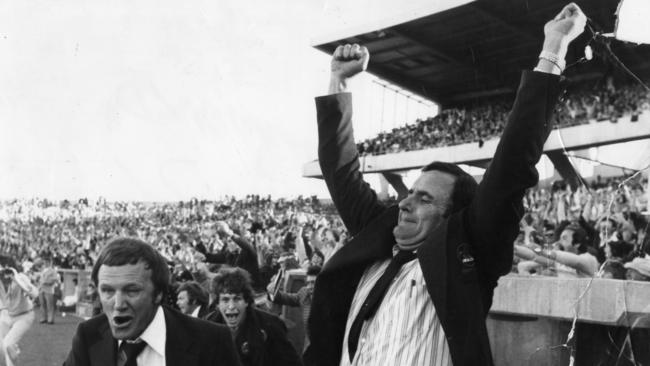 Norwood coach Bob Hammond raises his arms in triumph after his team beat Sturt in the 1978 SANFL grand final.