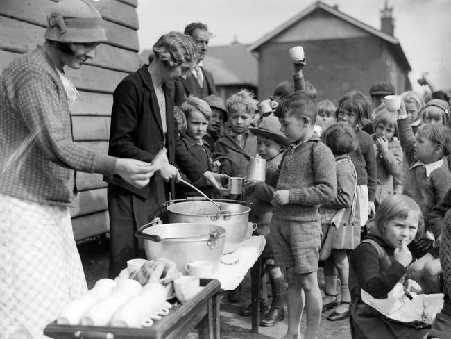 Sydney school children line up for free soup during the Great Depression in Sydney in 1934. Picture: Sam Hood of Hood Collection/State Library of NSW