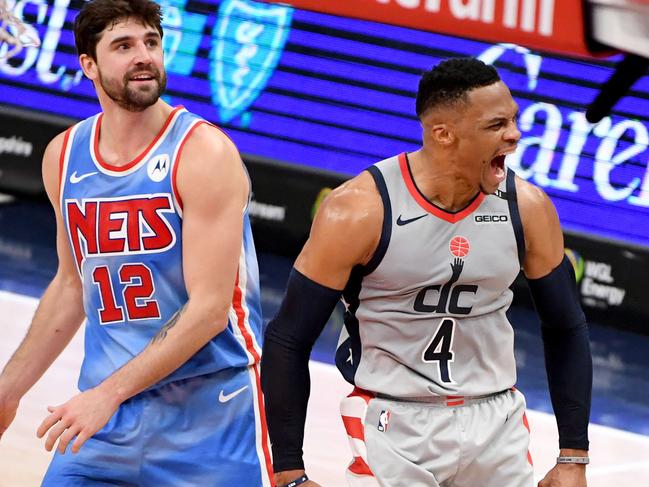 WASHINGTON, DC - JANUARY 31: Russell Westbrook #4 of the Washington Wizards celebrates in front of Joe Harris #12 of the Brooklyn Nets after making the game-winning shot during the second half at Capital One Arena on January 31, 2021 in Washington, DC. NOTE TO USER: User expressly acknowledges and agrees that, by downloading and or using this photograph, User is consenting to the terms and conditions of the Getty Images License Agreement.   Will Newton/Getty Images/AFP == FOR NEWSPAPERS, INTERNET, TELCOS & TELEVISION USE ONLY ==