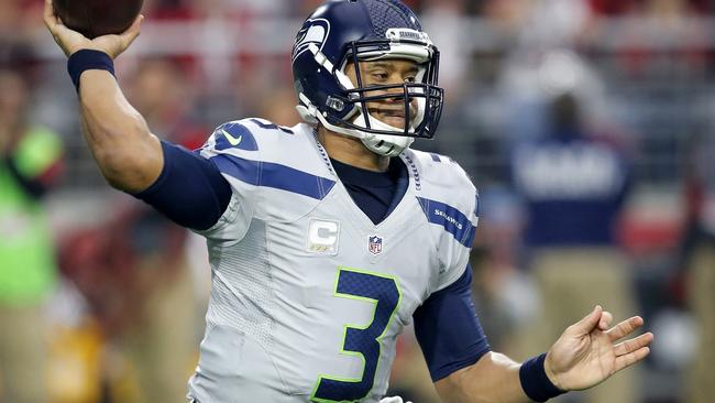 Seattle Seahawks quarterback Russell Wilson (3) lifts the Lombardi