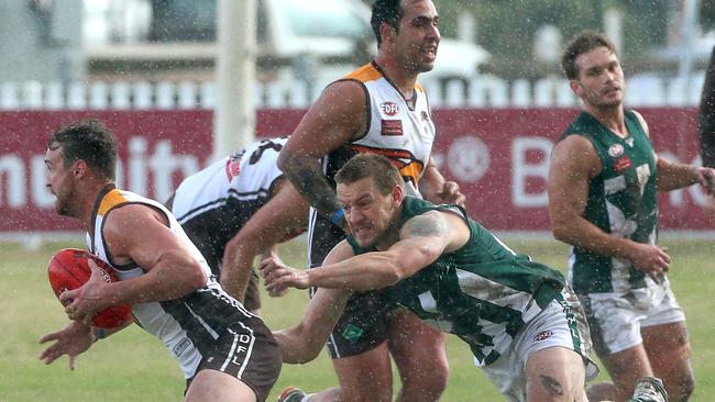 Picture of the week — Craigieburn’s Christian McErlain gets wrapped up by Airport West’s Matthew Bullock as rain falls during their EDFL clash. Picture: Hamish Blair.