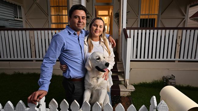 Jonathon Burrowes, Nina Clarke and Barney at their home in Red Hill, Brisbane. The interest rate rise means they plan to cut back on splurges. Picture: Lyndon Mechielsen / The Australian