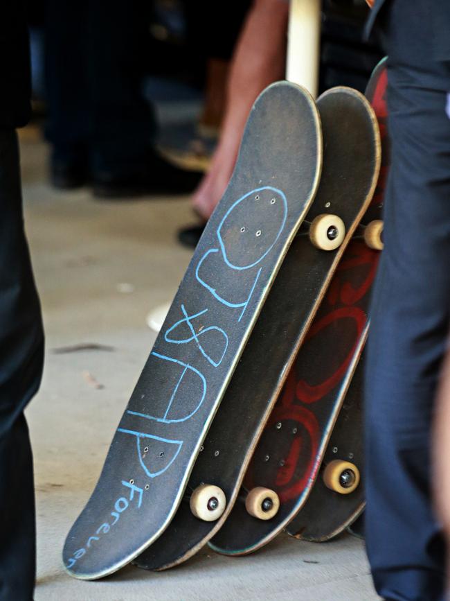 The names of their dead friends are written on their skateboards at the funeral of Angus Prior at Pittwater Uniting church. Picture: Adam Yip / Manly Daily