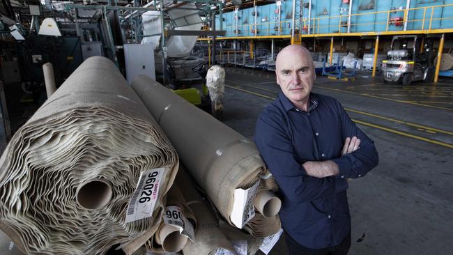 Victoria Carpets owner Phil Smith in his empty Dandenong factory. He says he can’t ‘understand why all manufacturing isn’t being treated equally’. Picture: David Geraghty