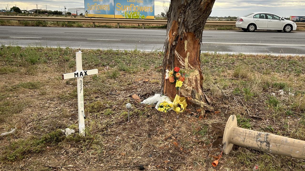 Tributes have been left at the site of a crash where a 27-year-old Elizabeth North man died on Sunday when his car collided with a light pole. Picture: Natalie Vikhrov