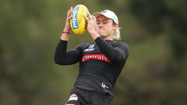 Darcy Moore climbs high to mark at Collingwood training. Picture: Michael Dodge. 