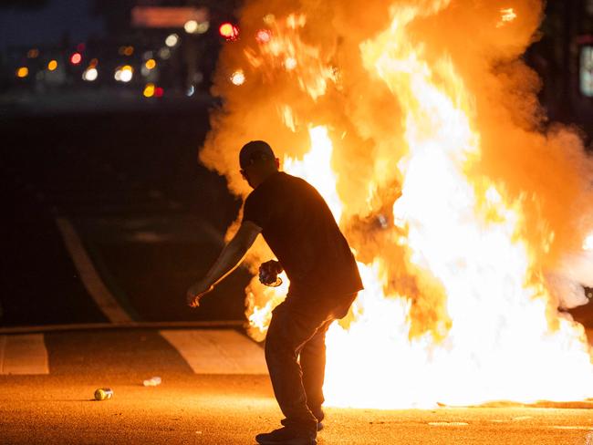 A protester clashes with law enforcement in the streets surrounding the federal building during a protest following federal immigration operations in Los Angeles. Picture: RINGO CHIU / AFP