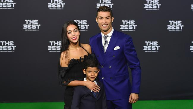 Cristiano Ronaldo posing with his partner Georgina Rodriguez and his son Cristiano Ronaldo Jr.