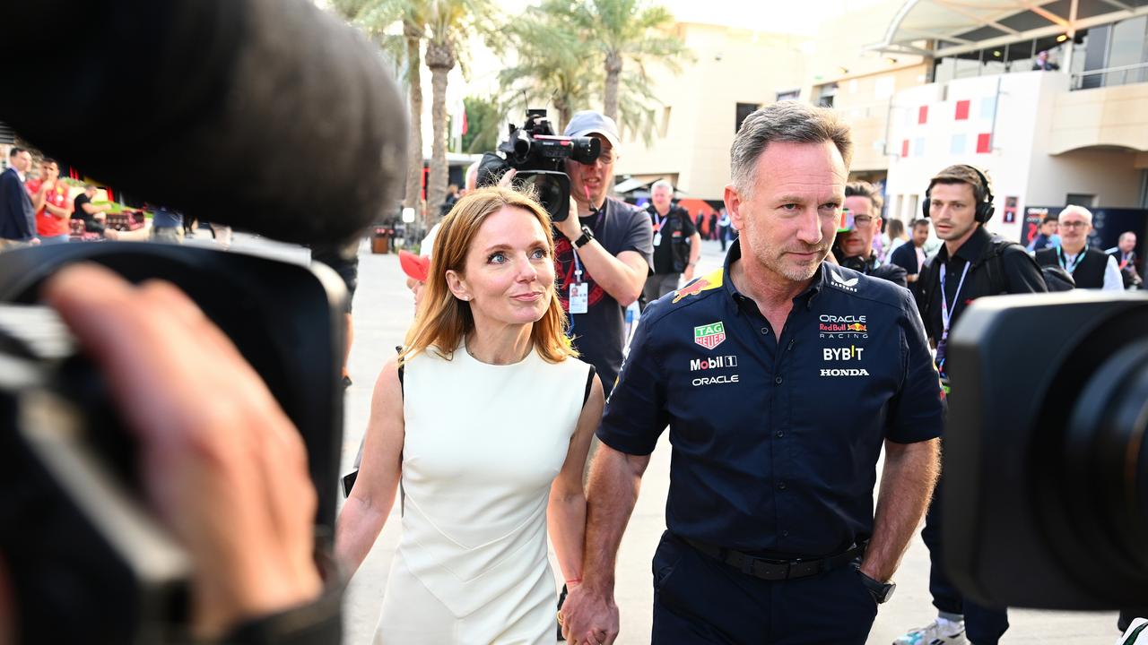 Christian Horner and Geri Horner walk in the Paddock holding hands. Photo by Clive Mason/Getty Images.
