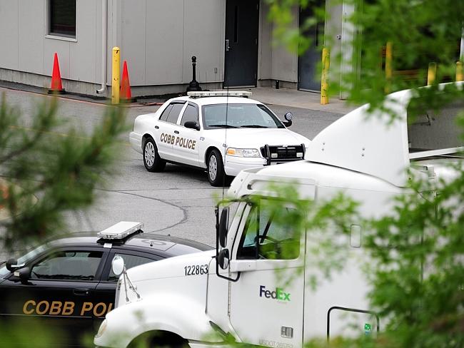 Six people were injured when a gunman opened fire at a FedEx station.