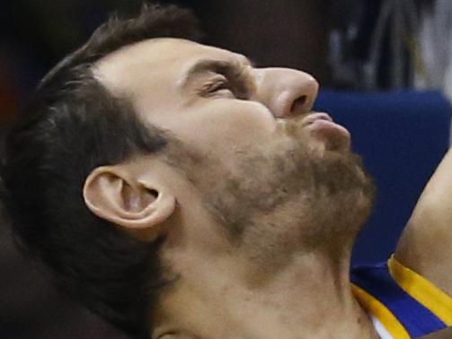 Golden State Warriors center Andrew Bogut, left, blocks a shot by Oklahoma City Thunder forward Serge Ibaka (9) in the first quarter of an NBA basketball game in Oklahoma City, Sunday, Nov. 23, 2014. (AP Photo/Sue Ogrocki)