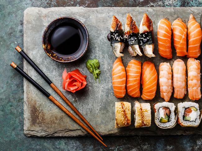 Sushi rolls set served on gray stone slate on metal background; ISTOCK