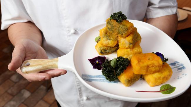 Executive Chef at District 8 restaurant at the Cabra-Vale Diggers club in Canley Vale Stevenson Su pictured holding the restraints popular dish Hand-Made Silky Tofu with Salted Egg Yolk. Photo by: Damian Shaw