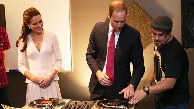 Catherine, Duchess of Cambridge looks on as Prince William, Duke of Cambridge is shown how to play on DJ decks at the youth community centre, The Northern Sound System in Elizabeth on April 23, 2014. Photo: Morne de Klerk - Pool/Getty Images.