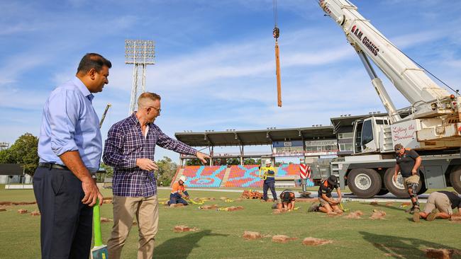 People, Sport and Culture minister Jinson Charls and NT Cricket CEO Gavin Dovey as TIO Stadium's drop-in pitch is laid down.