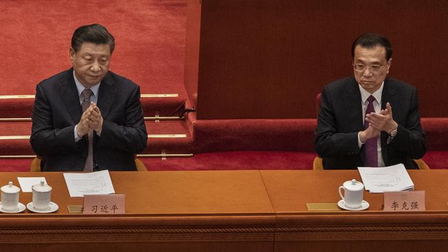 Chinese President Xi Jinping, left, and Premier Li Keqiang, right, applaud during the opening session of the Chinese People's Political Consultative Conference. Picture: Getty Images