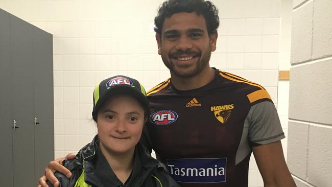 Celia Nash and her favourite Hawthorn player Cyril Rioli.