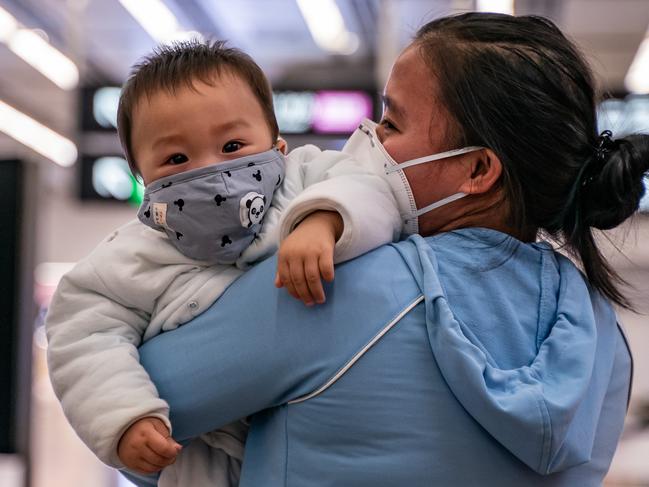 A woman and baby at the Hong Kong High Speed Rail Station in Hong Kong. Picture: Anthony Kwan/Getty