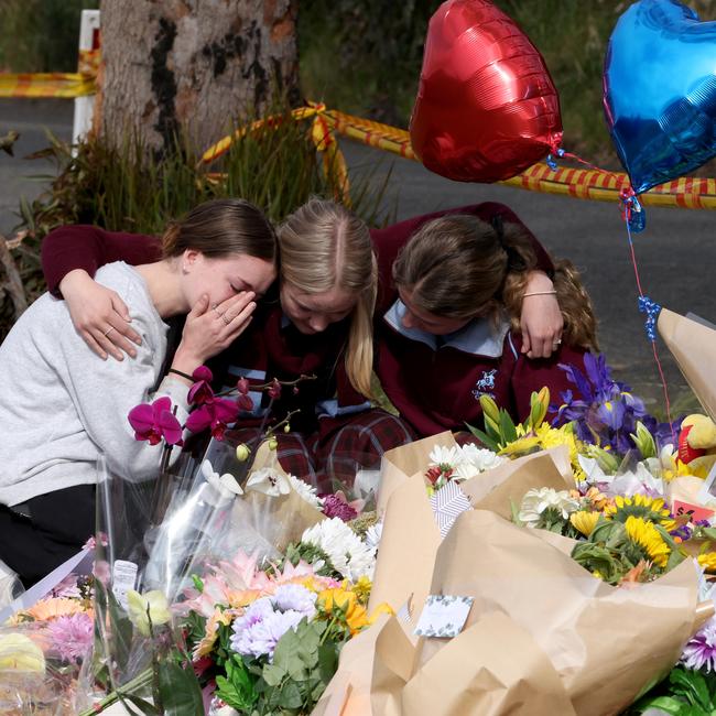 Students from Picton High school grieve at a shrine of flowers at Buxton. Picture: NCA NewsWire / Damian Shaw