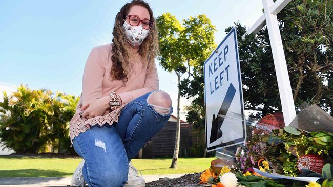 Parkville Street resident Lara Williams pays her respects at a roadside memorial to Liam Van Horen. Picture: Patrick Woods.