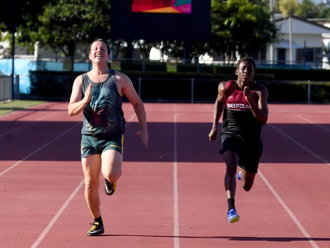 North Queensland sprint sensation Uwezo Lubenda, 15, up against Townsville Bulletin journalist Patrick Woods on the red track at the Townsville Sports Reserve. Picture: Evan Morgan